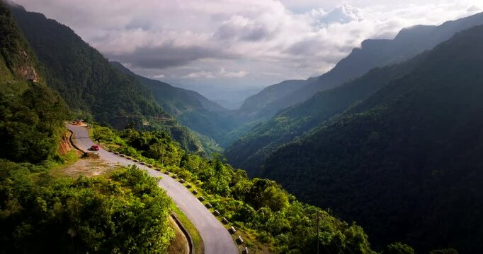 Ha Giang Loop in Vietnam, panoramic mountainous road, remote landscapes, deep valleys, adventurous trip. Aerial forward