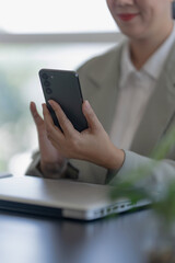 Business woman using mobile smartphone checking investment project