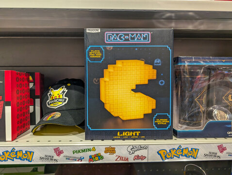 France, 15 July 2024 : Pac-Man light box beside Pikachu hat on store shelf