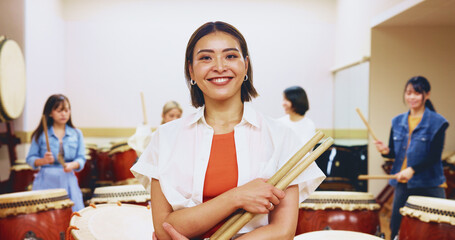 Portrait, happy and woman with drum sticks of teaching music, community practice and art performance. Teacher, arms crossed and instrument for festival band, musician session and team talent in Japan