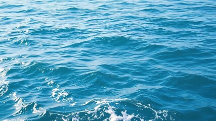 Fototapeta premium The ocean's surface is dotted with gentle ripples and waves on a sunny day, sun, calm atmosphere, gentle waves