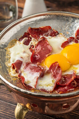 Traditional Turkish breakfast eggs with fried pastrami or bacon. Turkish name Pastirmali yumurta