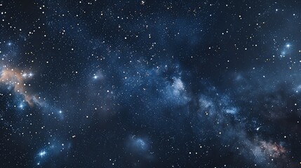 Obraz premium A breathtaking view of a starry night sky with a faint, swirling galaxy in the background.