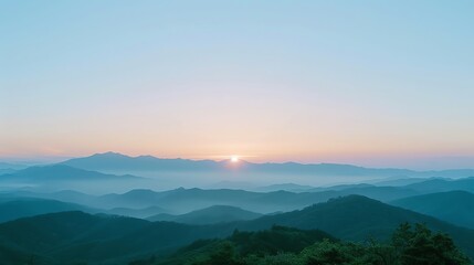 Obraz premium A view of rolling hills and a sunrise in the distance.