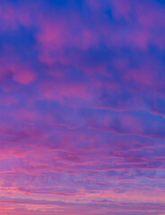 Vibrant Pink and Purple Sunrise Sky with Dreamy Cloudscape. Soft and Ethereal Morning Sky Colors Captured in a Peaceful Moment.