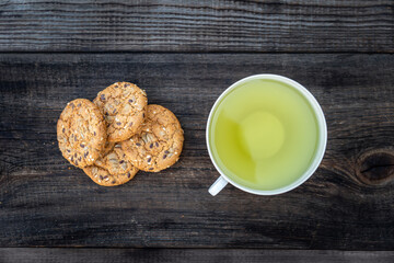 Oatmeal Cookies with Brazilian nuts and tea on wooden table. top view