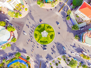 A difficult road intersection.

A drone shot from above of the intersection in Nha Trang in Vietnam of 7 roads. In the center of the intersection there is a flower bed in the shape of a star and a lig