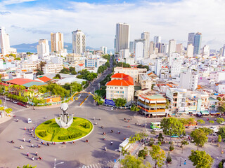 A difficult road intersection.

A drone shot from above of the intersection in Nha Trang in Vietnam of 7 roads. In the center of the intersection there is a flower bed in the shape of a star and a lig