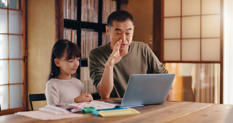 Asian father, daughter or laptop with video call for online learning, language tutoring or teaching at home. Japan, dad and child with computer for virtual classroom, lesson or homeschooling at house