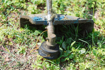 Plastic line in a lawn mower reel - mowing the lawn with a rotating line