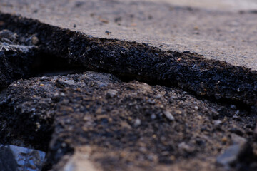 Soil, rocks, sand, damaged asphalt roads