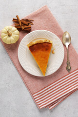 Flat lay composition with piece of fresh delicious homemade pumpkin pie and space for text on napkin