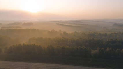 Golden sunlight breaking through misty valley