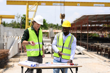 Engineers and foremen wearing hard hats in factory. Hard hats talking on construction site.