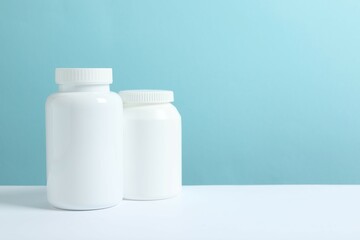 White bottles on color background 