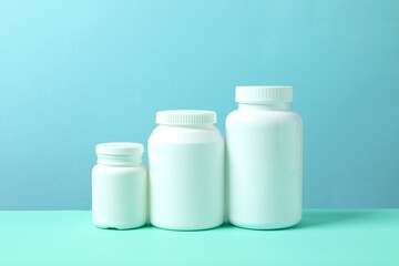 White bottles on color background 
