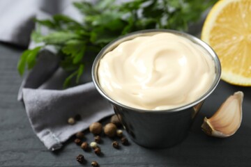 Bowl with mayonnaise and ingredients for cooking on wooden background