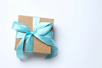 Beautiful gift box tied with bow on white background 