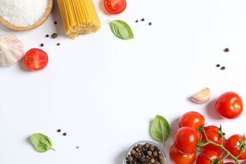 Composition with pasta and cooking ingredients on white background, top view