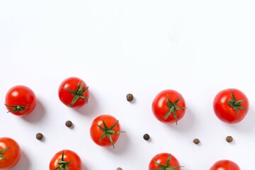 Fresh red tomatoes, pepper on white background, top view