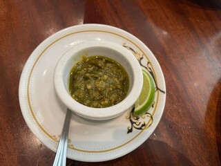 Delicious Green Chili Sauce Served on Elegant Plate with Lime Wedge A Culinary Delight from Indonesian Cuisine