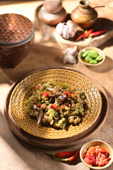 Sambal pare (sambel pare) is an Indonesian dish of stir-fried bitter melon coated in spicy sambal, balancing bitterness with savory, spicy, and slightly sweet flavors. Perfect with rice!