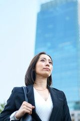 空を見上げるビジネスウーマン