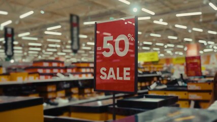 Customers explore a store filled with vibrant displays and enticing discounts as they hunt for bargains during a significant sale event. Excitement fills the air as shoppers browse.