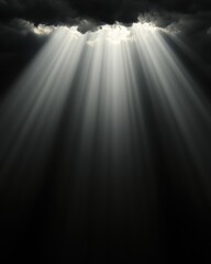 Obraz premium A dramatic scene featuring beams of light piercing through dark clouds, creating an ethereal and moody atmosphere.