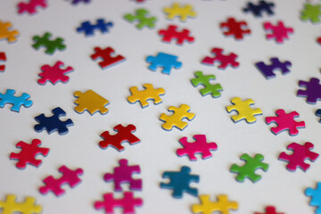 Colorful jigsaw puzzle pieces on white background. Selective focus.