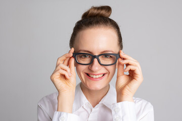 Portrait of smiling woman wearing glasses isolated on white studio background. Eyesight test and...