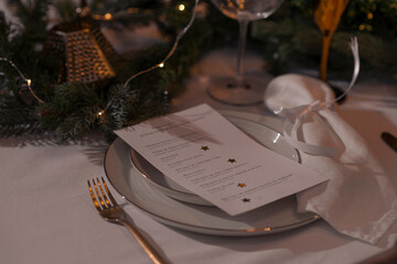 New Year table setting with lantern candles, festive tableware and calligraphy 