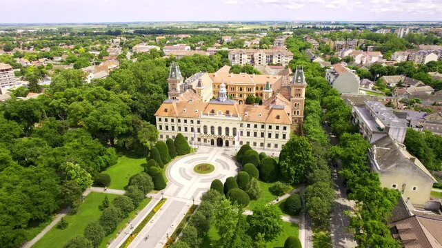 Historic building surrounded by lush greenery in a serene park setting captures the beauty of nature and architecture in harmony