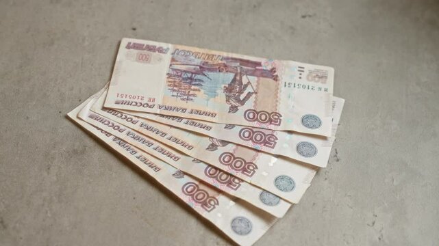 Russian ruble banknotes on a concrete surface emphasizing financial context in russia.