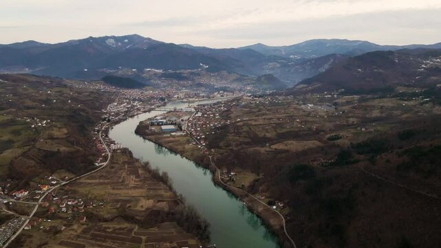 Stunning drone view of the Vardar River winding through rural landscapes in Macedonia during early spring