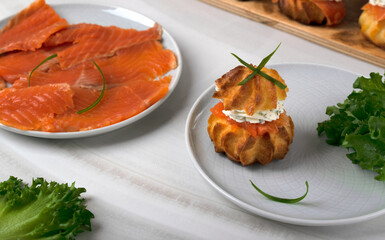 Profiteroles with salted trout and cream cheese with dill. Festive appetizer, buffet dish