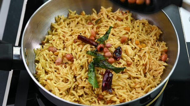 Preparing tamarind rice Indian spicy rice dish.