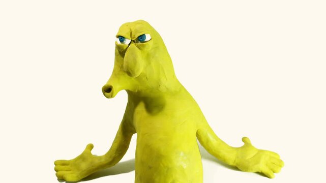stop motion animation of a cartoon yellow plasticine character flexing his biceps