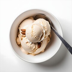 Vanilla ice cream scoops in a white bowl with almonds