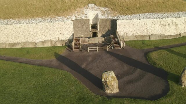 Upright Stones in Front Of Newgrange Entrance At Sunrise In County Meath, Ireland. - aerial shot