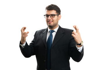 Hopeful male entrepreneur smiling making good luck gesture