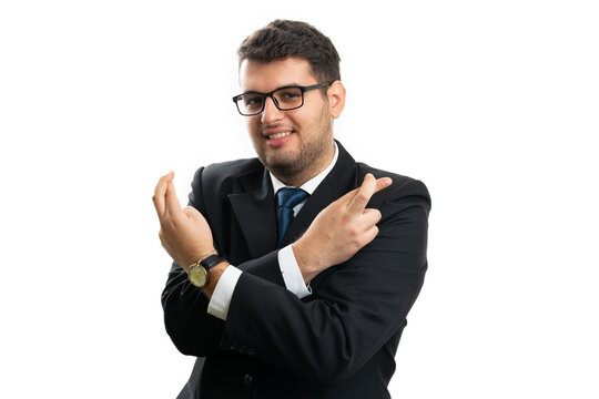 Businessman smiling as holding fingers crossed good luck gesture