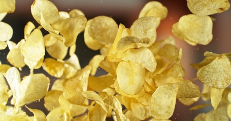 Fototapeta premium Flying Potato Chips, Fried Potatoes Flying up in the Air.