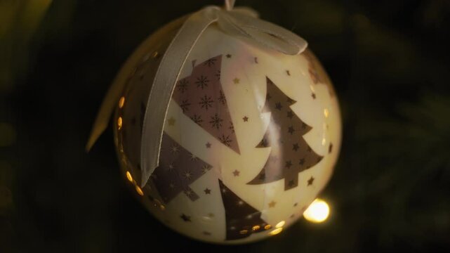 Sad Embroidered Christmas Ball Near Dark Tree