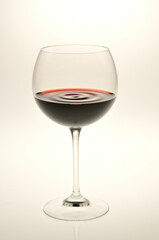 Red wine swaying in a glass / 赤ワインがグラスの中で揺れている