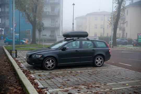Black volvo v50 d5 kinetic station wagon parked on foggy autumn day