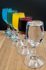 Colorful alcohol in shot glasses.
