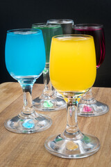 Colorful alcohol in shot glasses.

