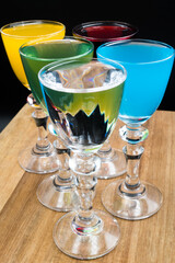 Colorful alcohol in shot glasses.
