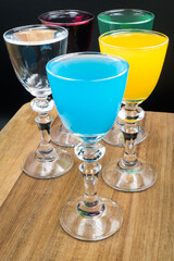 Colorful alcohol in shot glasses.
